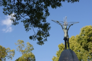 In addition to thousands of adults, many children died in the bombing or from radiation sickness afterwards. The Children's Peace Monument stands as a memorial to these children. At the top of the monument is the statue of a young girl holding a crane, inspired by Sadako Sasaki who was only two when she was exposed to the radiation from the bombing. She developed leukemia at age seven and died. Before her death, she folded paper cranes, as a Japanese legend states that anyone who can folder 1000 cranes will have their wish granted. Sadako was never able to fold all 1000, but others around the world carry on folding, wishing for peace. By Erin Grace, CC BY-SA 3.0.